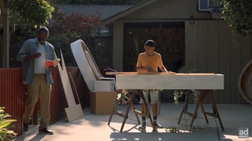 Dad helping son work on prom sign