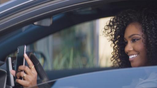 Woman taking a selfie in her car