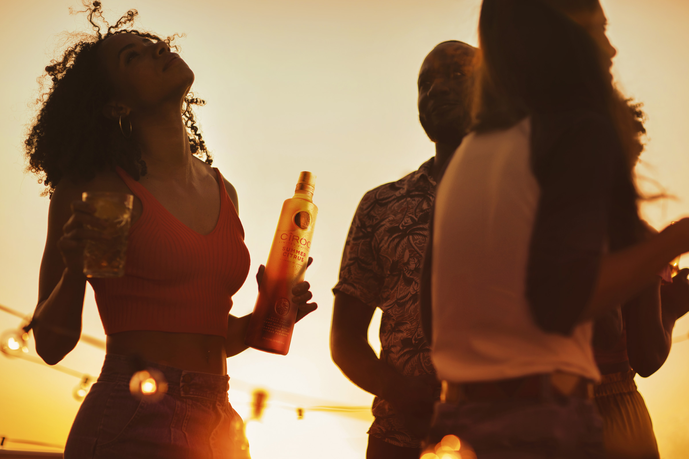 Party with women and a bottle  of CÎROC Summer Citrus.