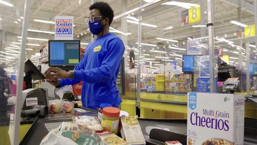 No Frills cashier serves customer