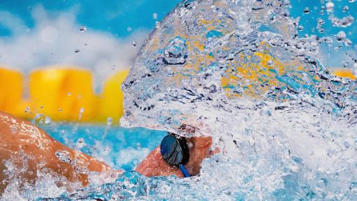 A swimmer surrounded by a swirl of water in a pool