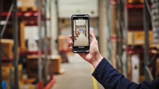 Image of a warehouse. In the warehouse, read NFC tags, or use one-button scanning to track virtually anything. The high-res rear/front cameras capture detailed images.