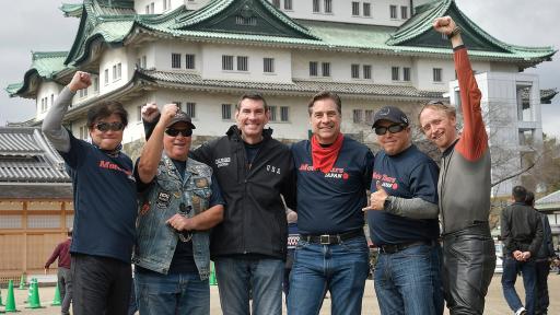 Image of six people in front of Nagoya Castle &ndash; the group is amazed by its magnificence.