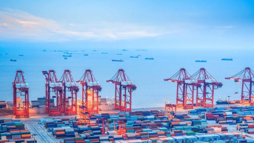 Image of container port with ships in distance