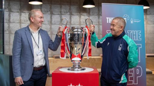 ceo ben dorks and graham moran looking at eachother with cup