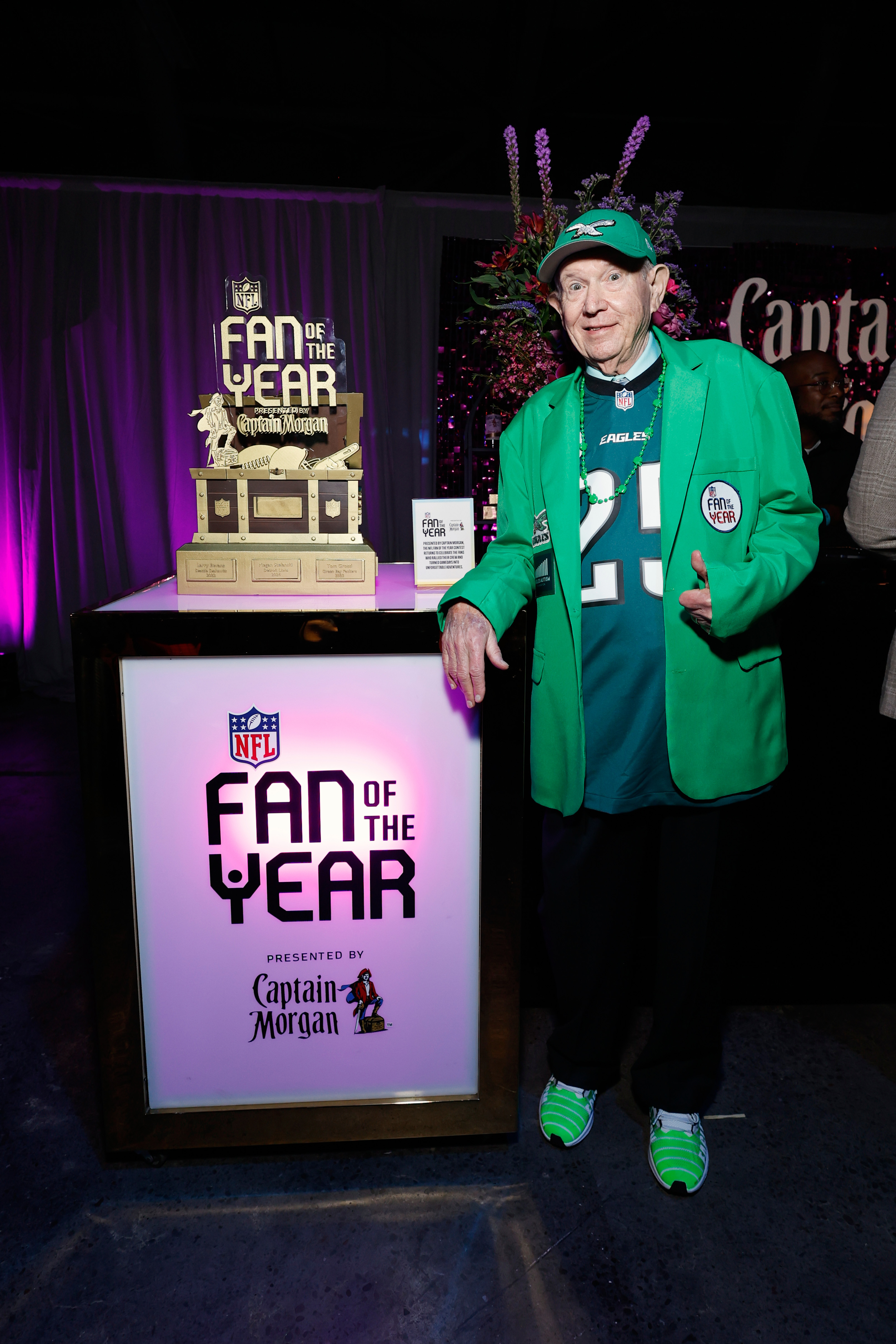Captain Morgan presents the 2025 NFL Fan of the Year trophy to Ed Callahan