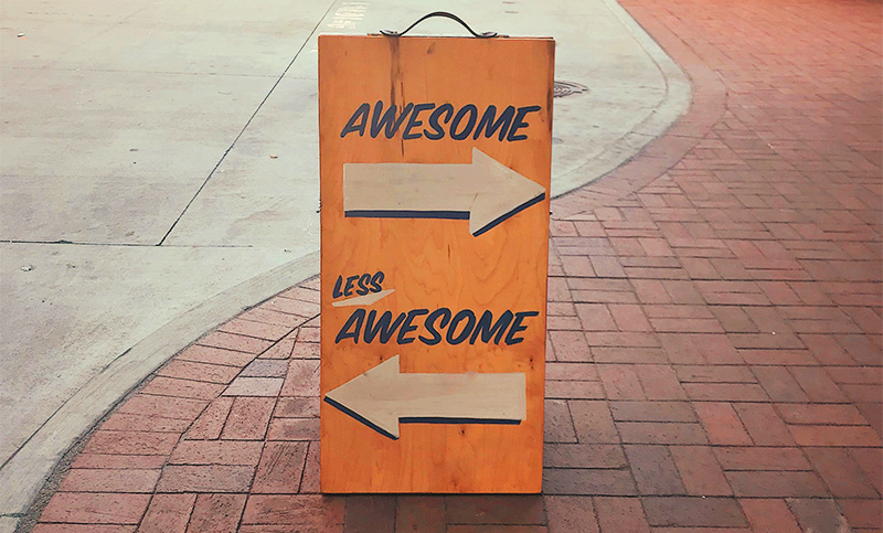 sign that reads awesome with arrow pointing right and less awesome with arrow pointing left