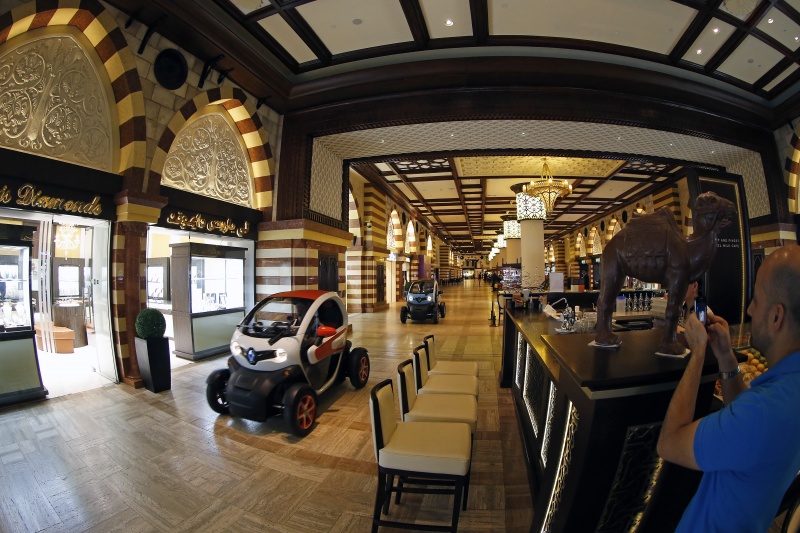 LOTUS F1 TEAM DRIVING RENAULT TWIZY INSIDE THE DUBAI MALL