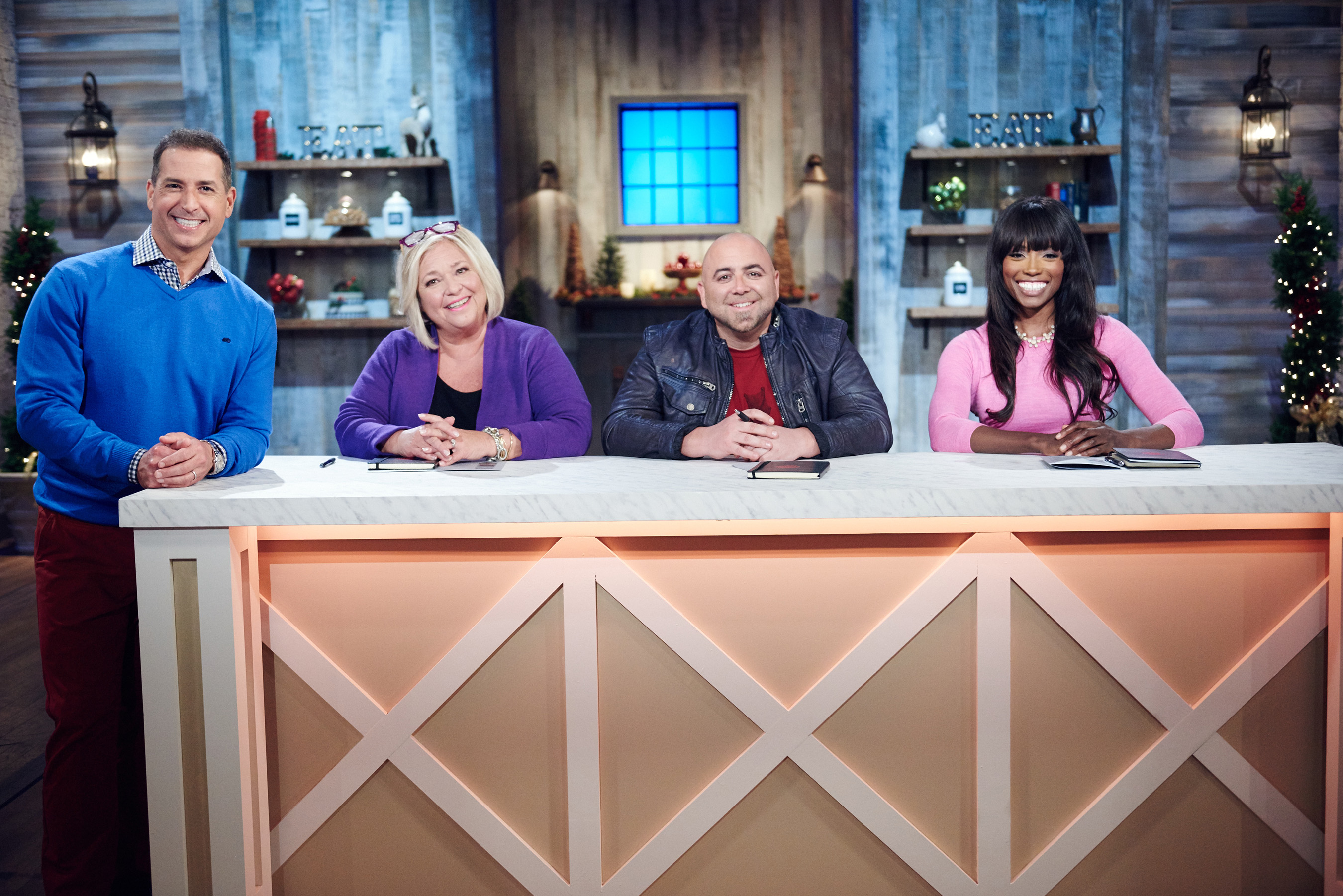 Host Bobby Deen with Judges Nancy Fuller, Duff Goldman and Lorraine Pascale on Food Network's Holiday Baking Championship