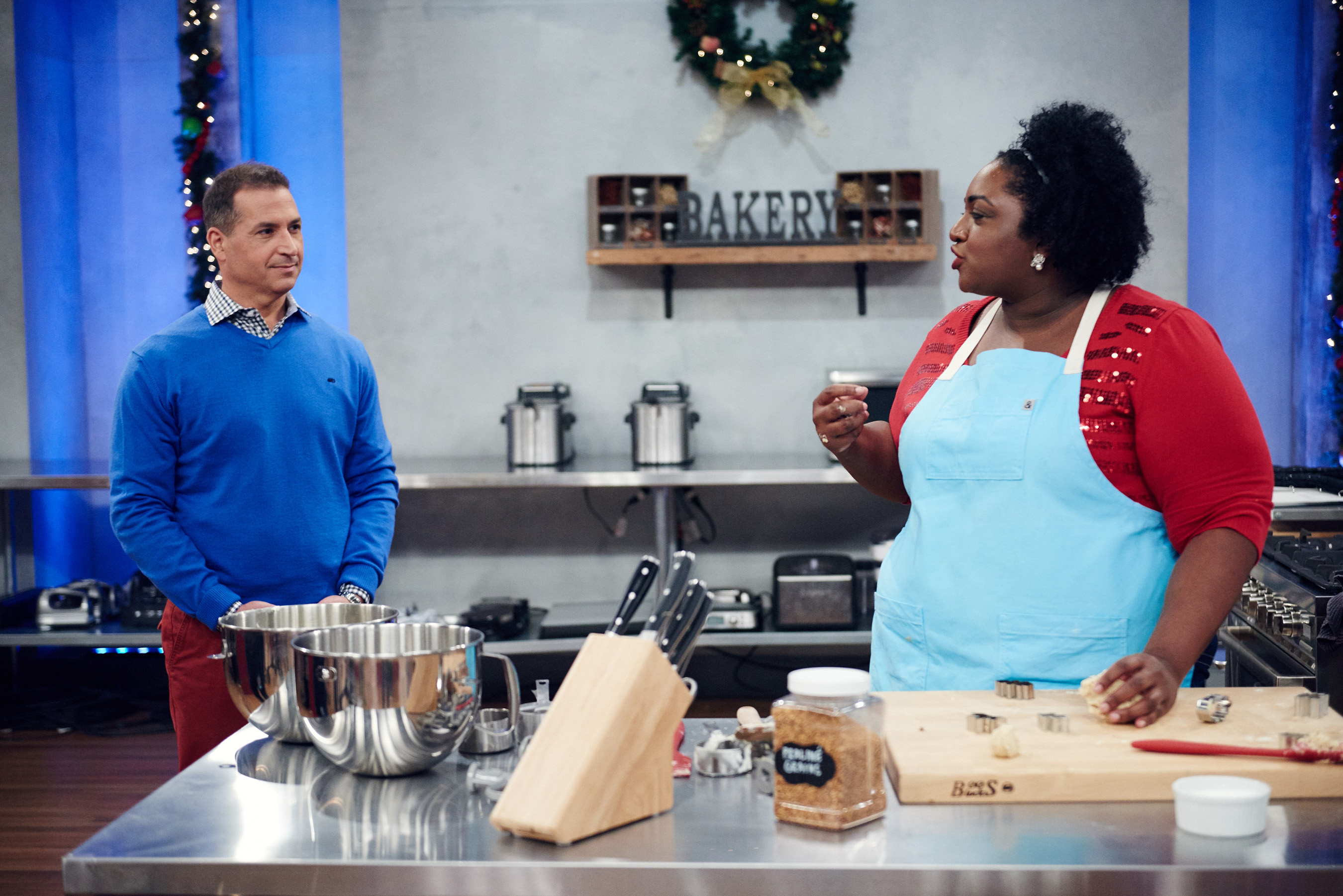 Host Bobby Deen checks in on contestant Amber Croom on Food Network's Holiday Baking Championship