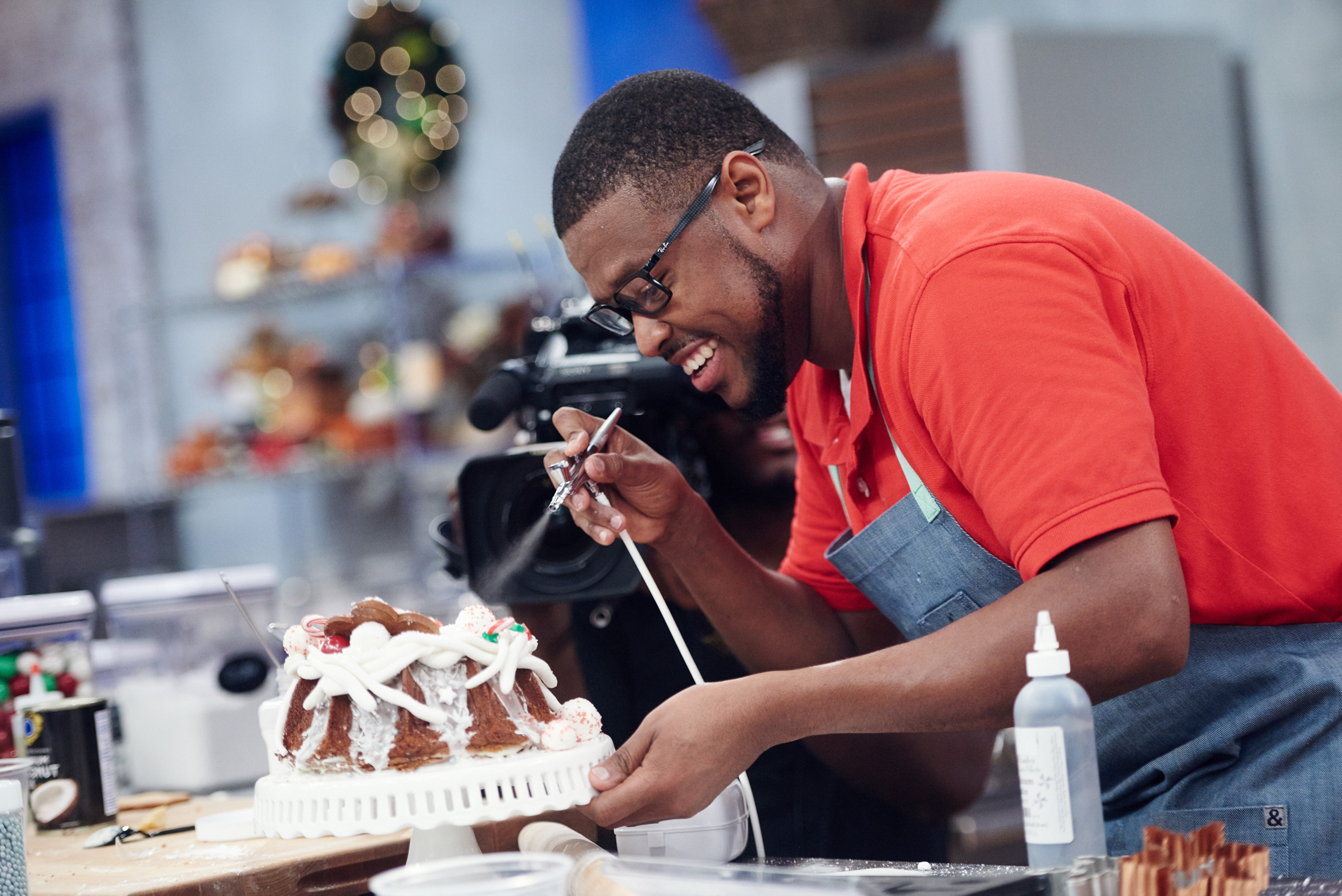 Contestant Shawne Bryan preparing his dish on Food Network's Holiday Baking Championship