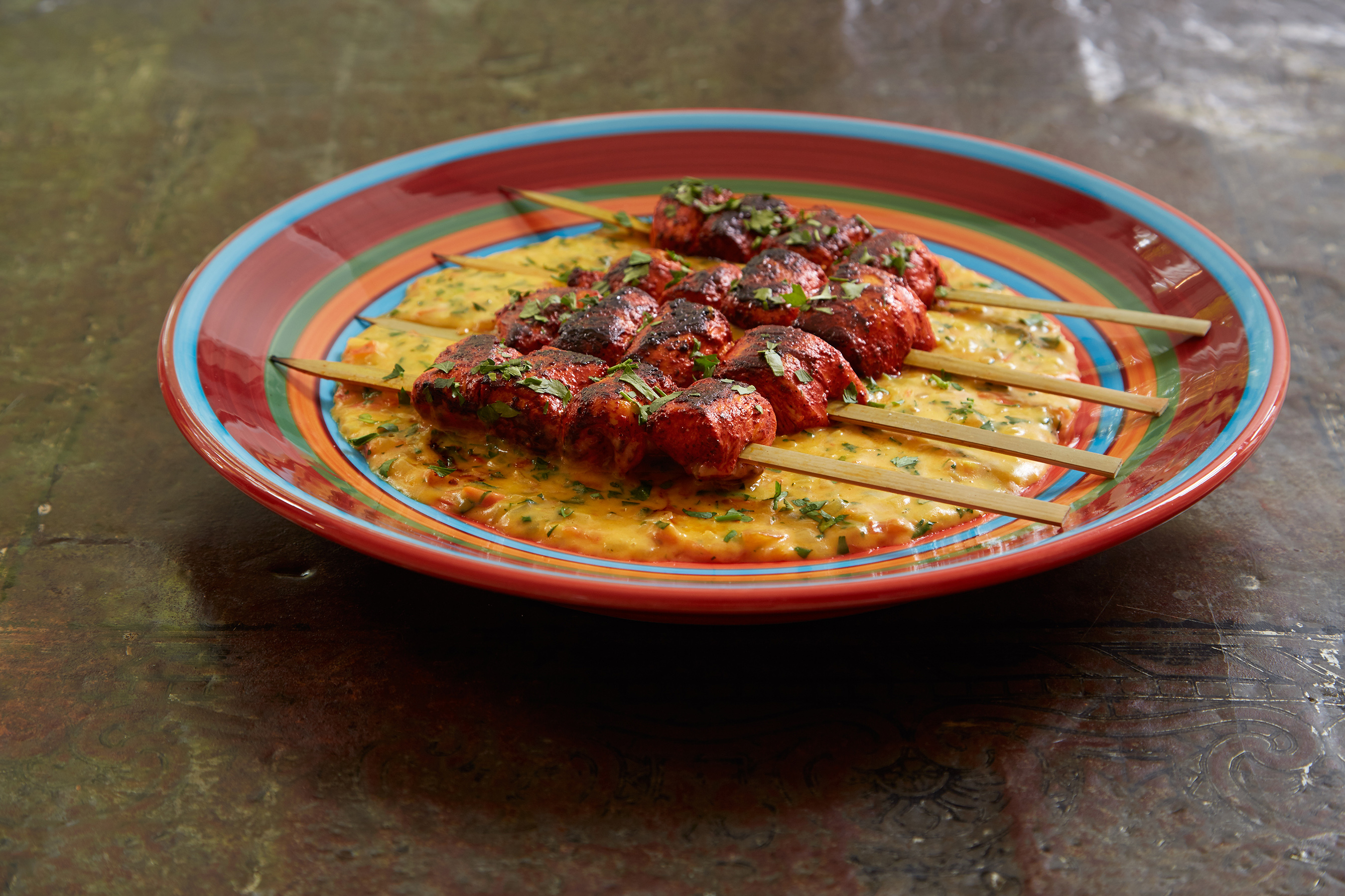 Looking for a bit of spice? Try these pan roasted achiote-rubbed chicken skewers with Crystal Farms® Oaxaca cheese sauce.