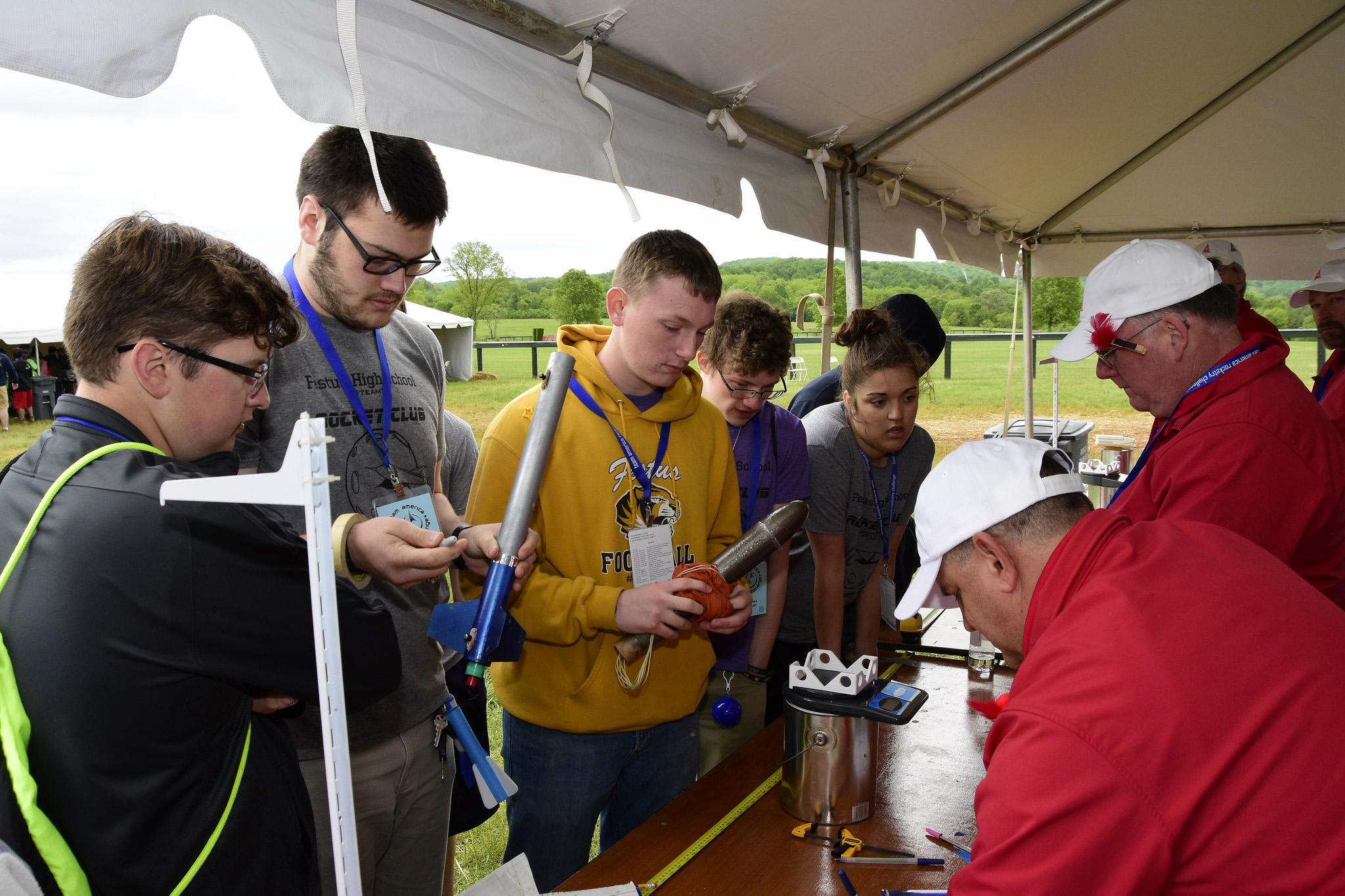 Festus HS wins TARC 2017: Festus High School students Ed Bohnert, Joel Marler, Ryan Brown, Christopher Carden, and Grace Basler (left to right) bring the winning flight to the judges (credit: National Association of Rocketry).