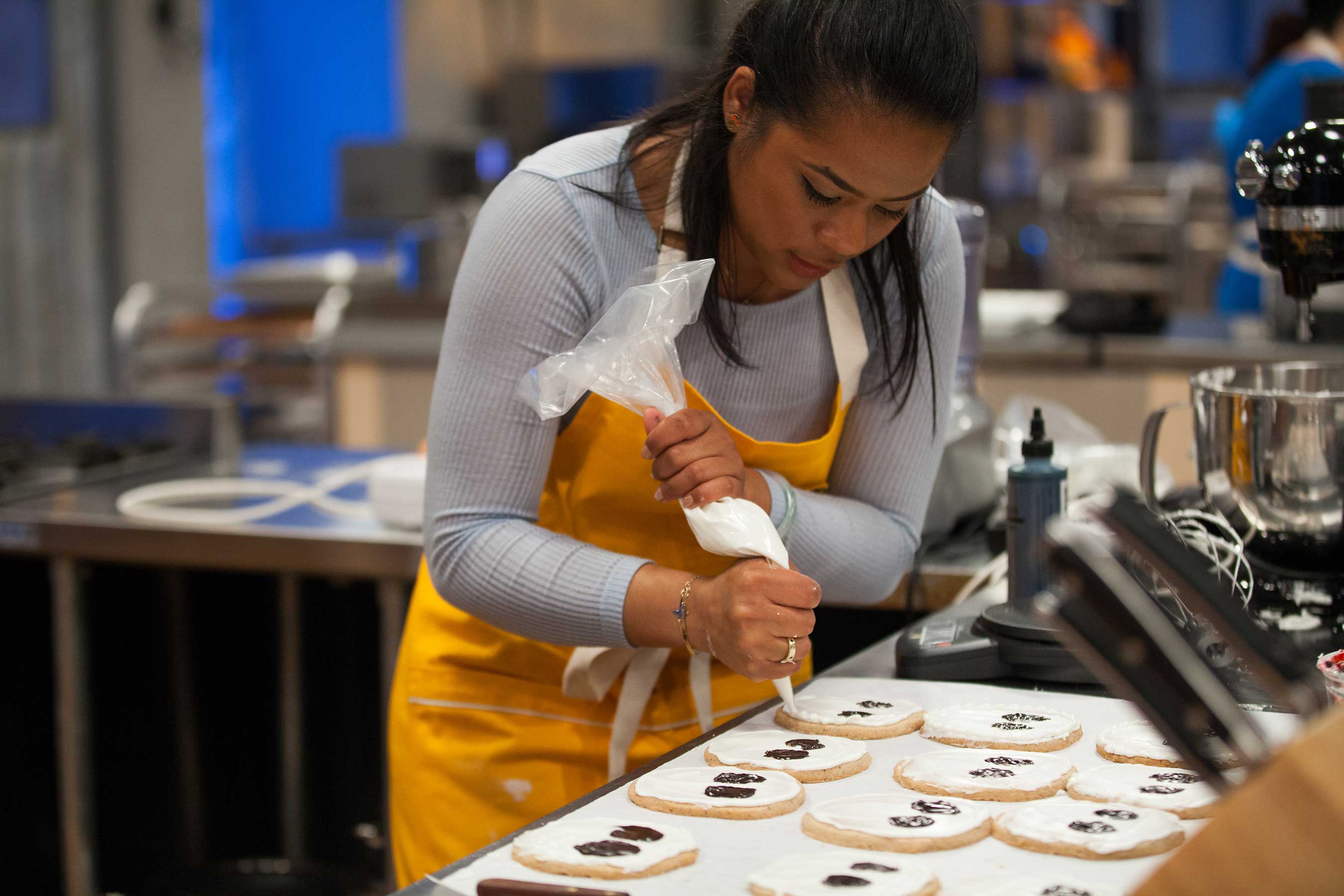 Baker Jasmin Bell rushes to finish decorating Halloween cookies on Food Network's Halloween Baking Championship
