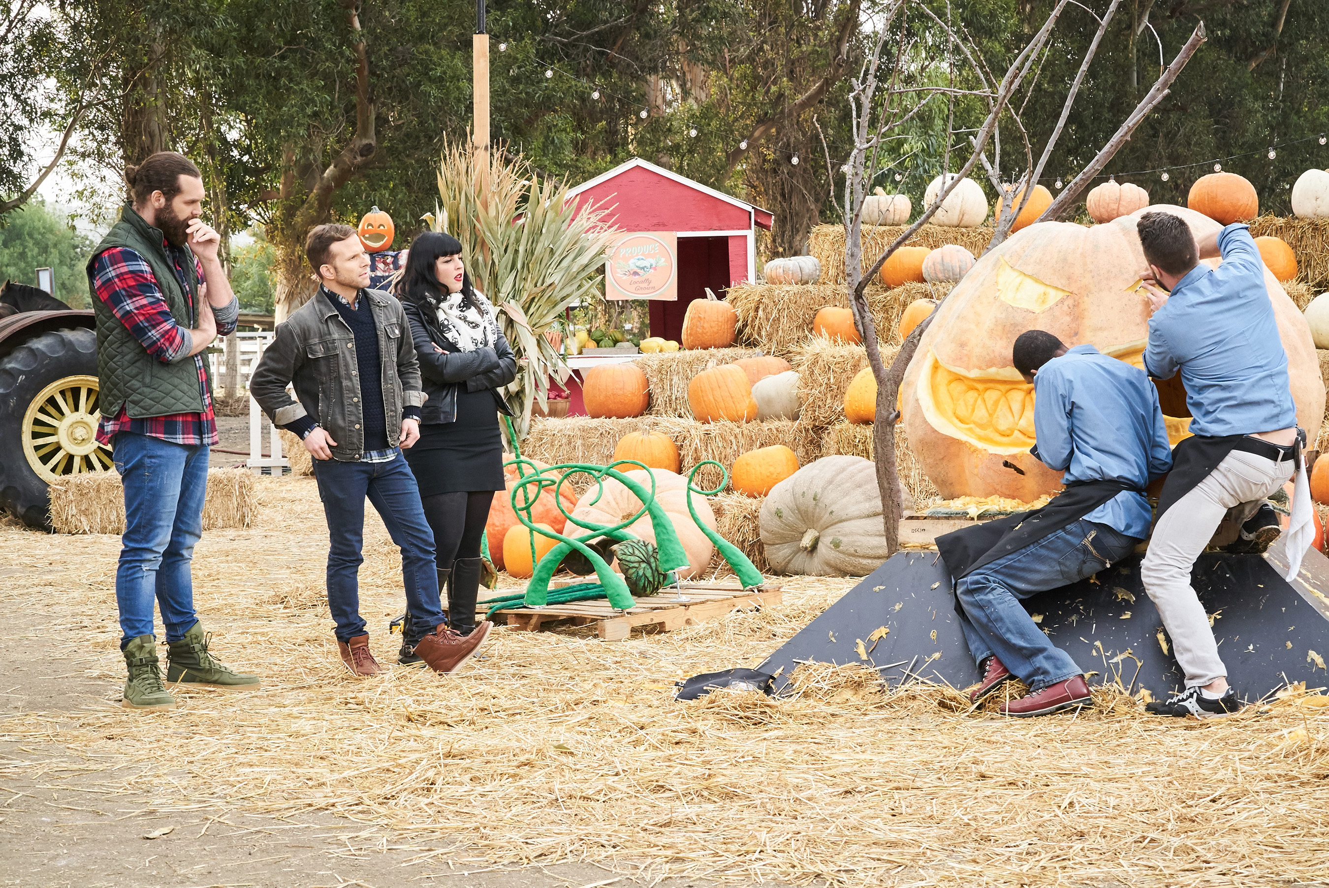 Host Harley Morenstein and judges Zac Young and Bianca Appice watching competitors on Food Network’s Halloween Wars: Hayride of Horror