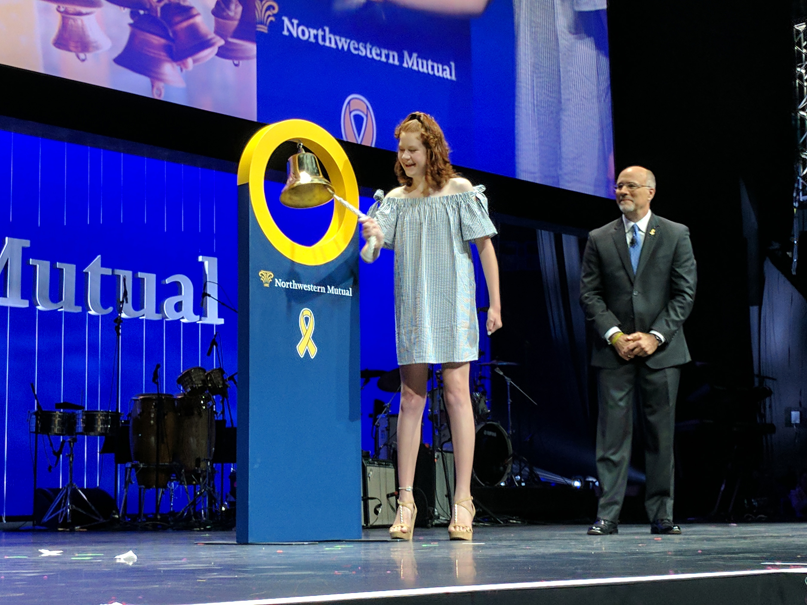 Childhood cancer survivor Peyton Richardson rings a bell at Northwestern Mutual’s Annual Meeting to symbolize the end of her treatment and celebrate the company’s dedication to the fight.