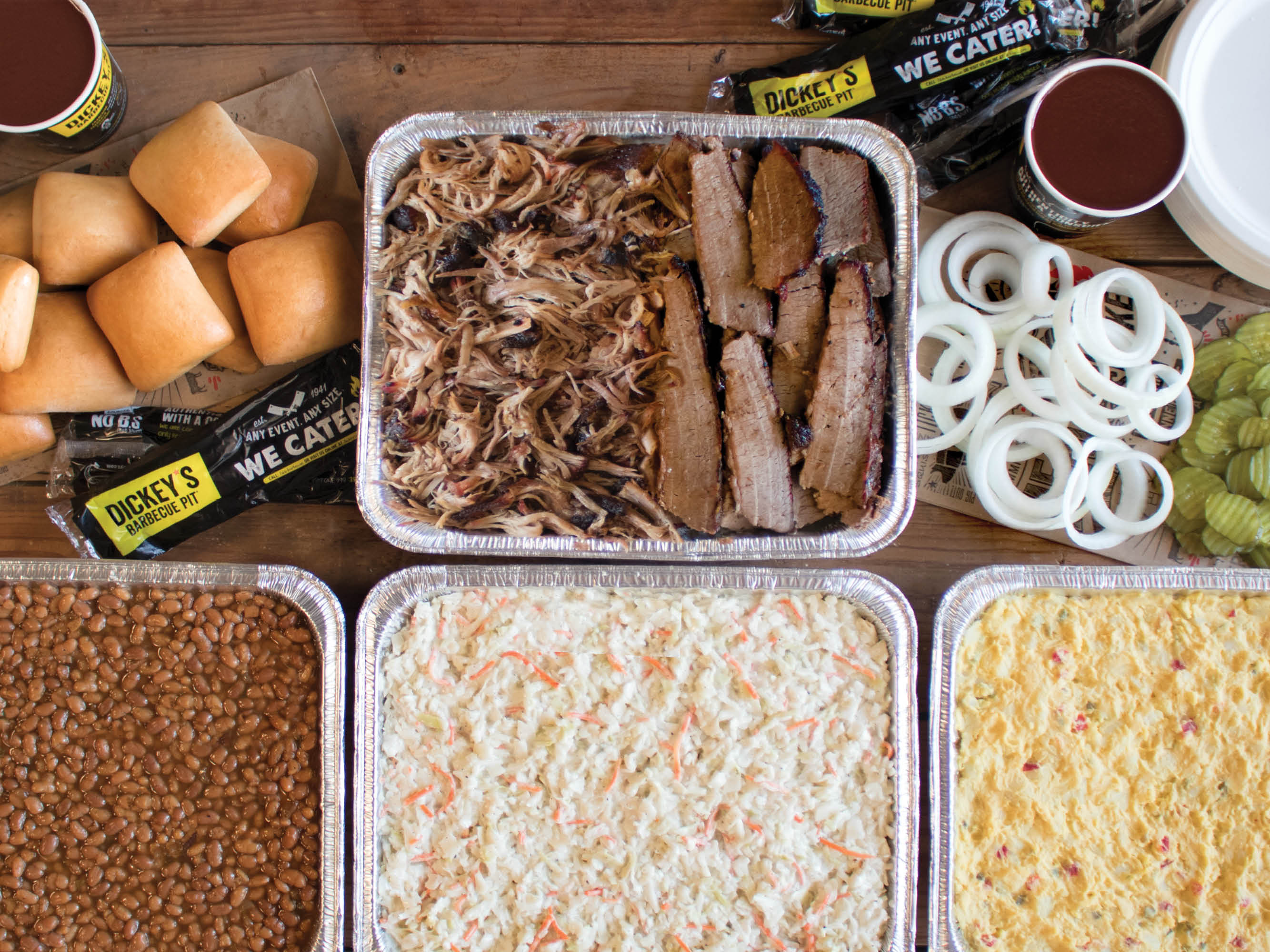 Dickey’s Tailgate Party Pack offers four pounds of slow-smoked meats along with potato salad, coleslaw, barbecue beans, and 12 buttery rolls.