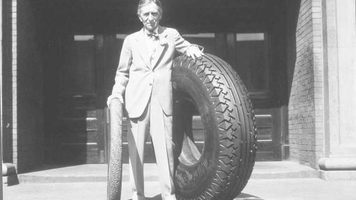 Harvey S. Firestone with an original non-skid tire and an oversized tire.