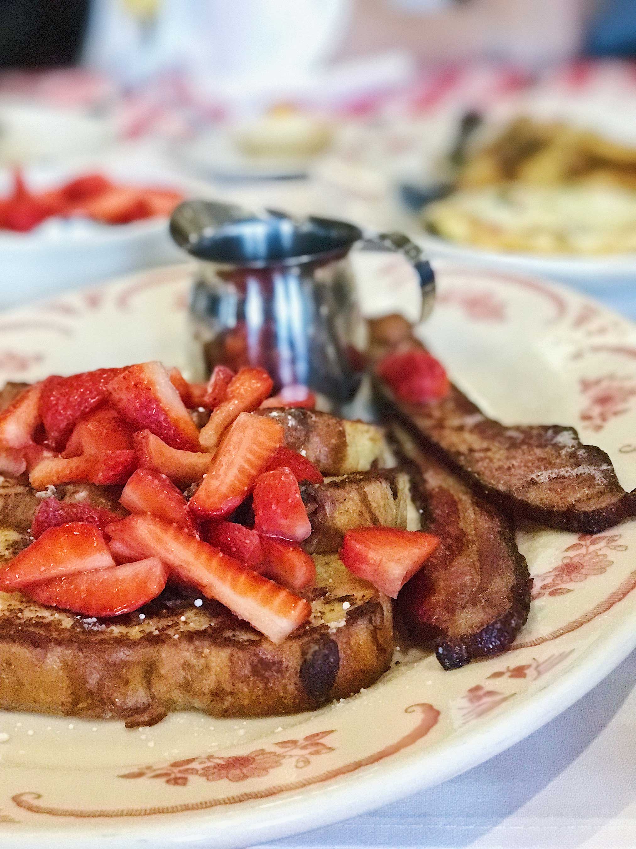 Crème Brûlée French Toast made with cranberry raisin focaccia and served with maple syrup and fresh strawberries  Credit: Chase White