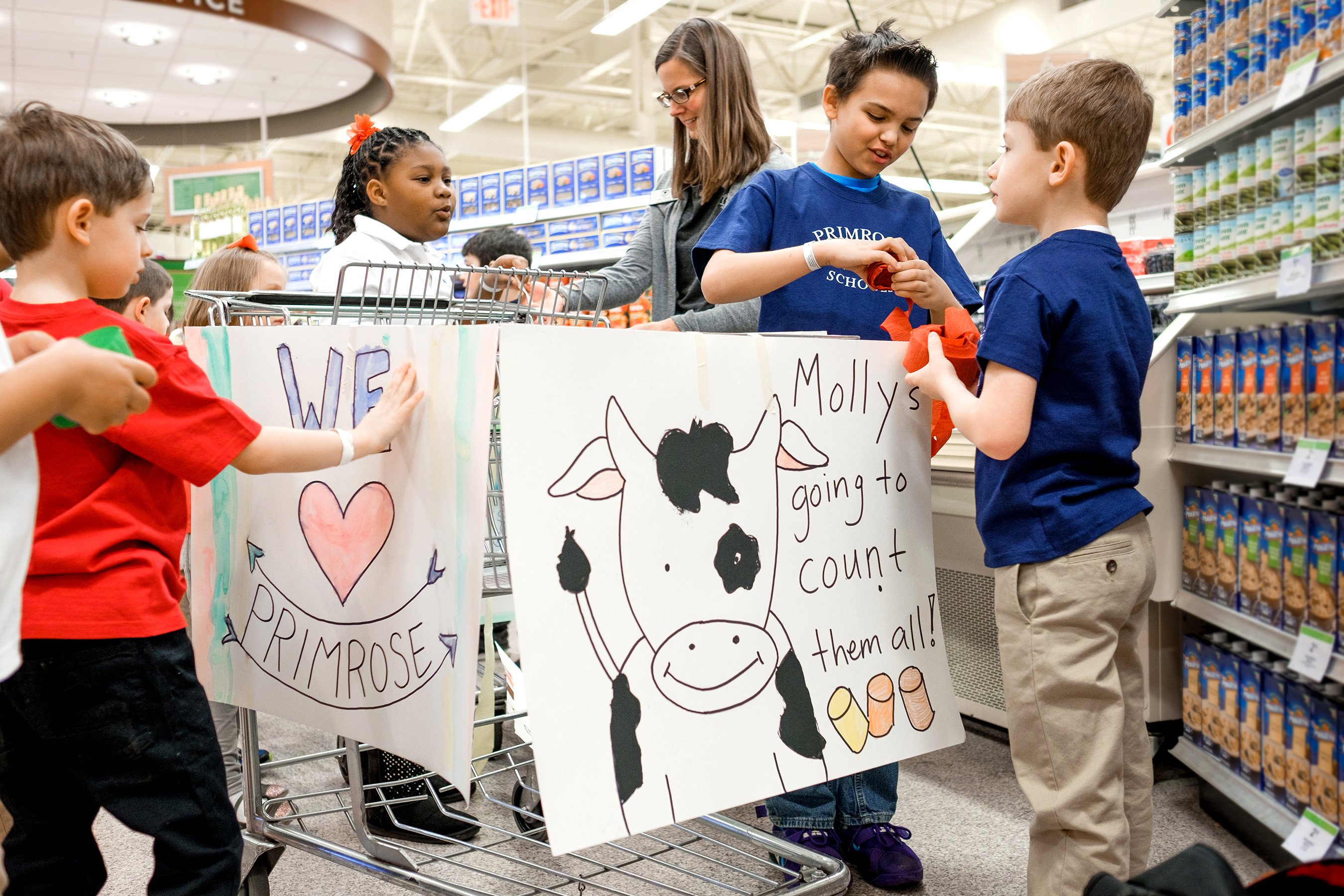 Primrose preschoolers shop for food to donate as part of the annual Caring and Giving Food Drive. The Primrose Balanced Learning approach includes nurturing generosity in children of all ages.