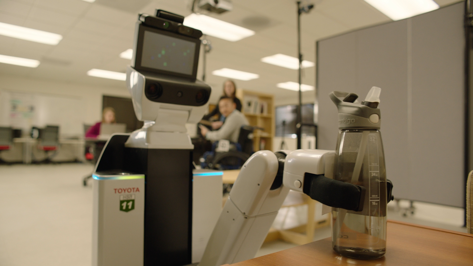 Toyota’s Human Support Robot (HSR) picks up a bottle of water. The HSR is designed to assist people with limited mobility, including helping with everyday tasks, such as opening doors and delivering water bottles or snacks from the pantry. Toyota’s Human Support Robot (HSR) picks up a bottle of water. The HSR is designed to assist people with limited mobility, including helping with everyday tasks, such as opening doors and delivering water bottles or snacks from the pantry.