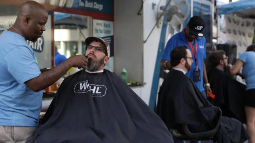 Men having their beards trimmed and styled.