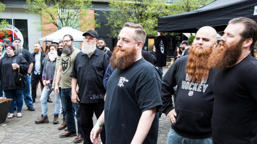 People standing in a crowd, most being men with long beards
