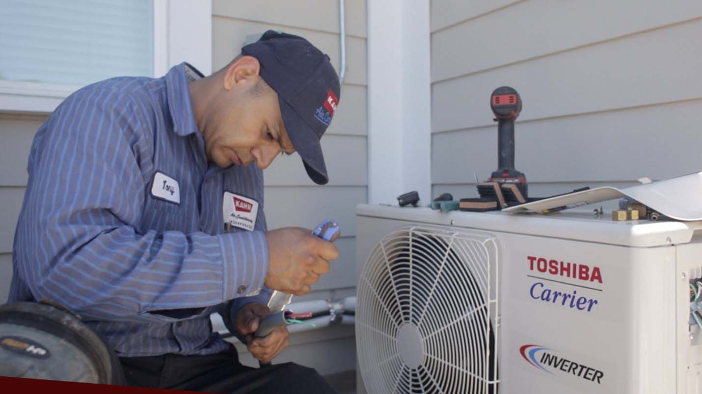 A technician from Kahn Air works to install a Carrier ductless heat pump at the Los Angeles home of Tamara as part of the donation Carrier made of more than 500 home comfort systems to Habitat for Humanity.