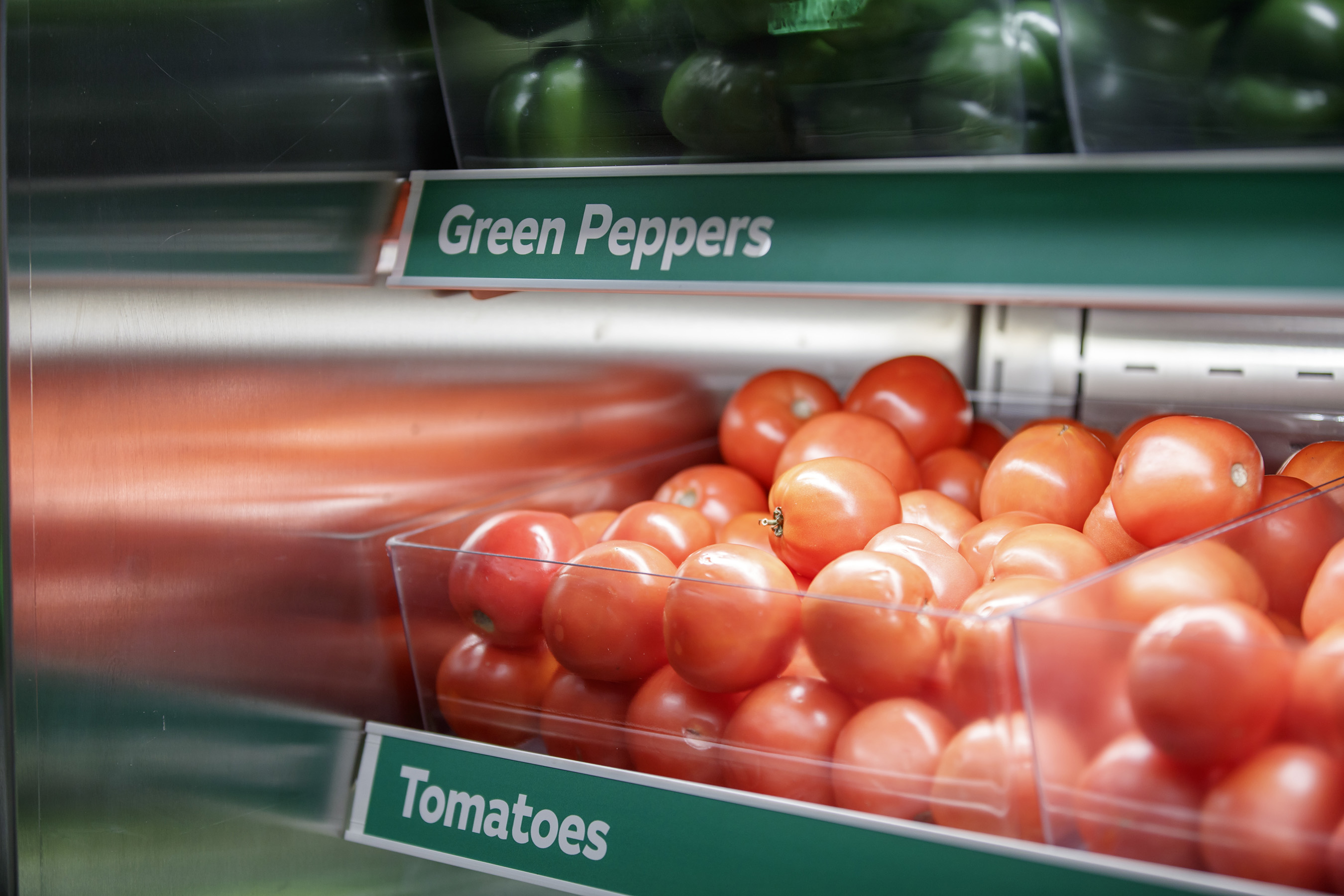 Fresh veggies - whole tomatoes, green peppers, onions and cucumbers - that are sliced daily are highlighted in modern food displays.