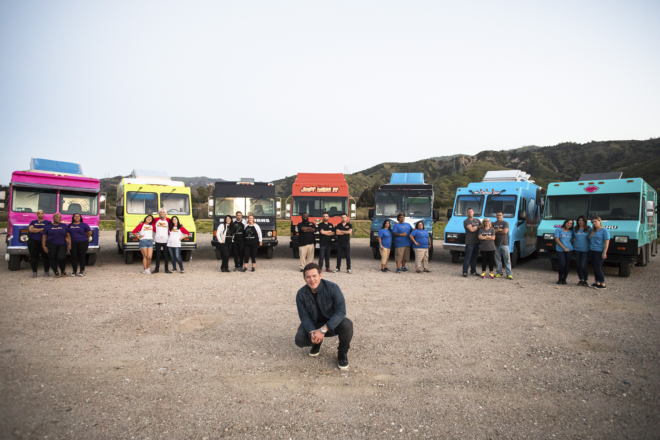 Host Tyler Florence with the teams on Food Network's The Great Food Truck Race
