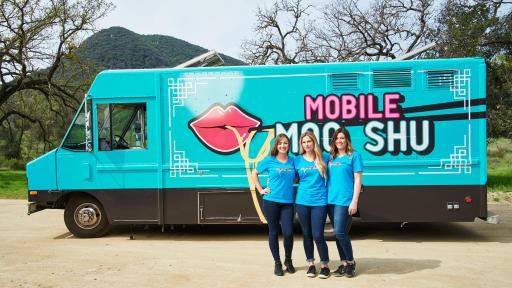 Team Mobile Moo Shu stand in front of their food truck