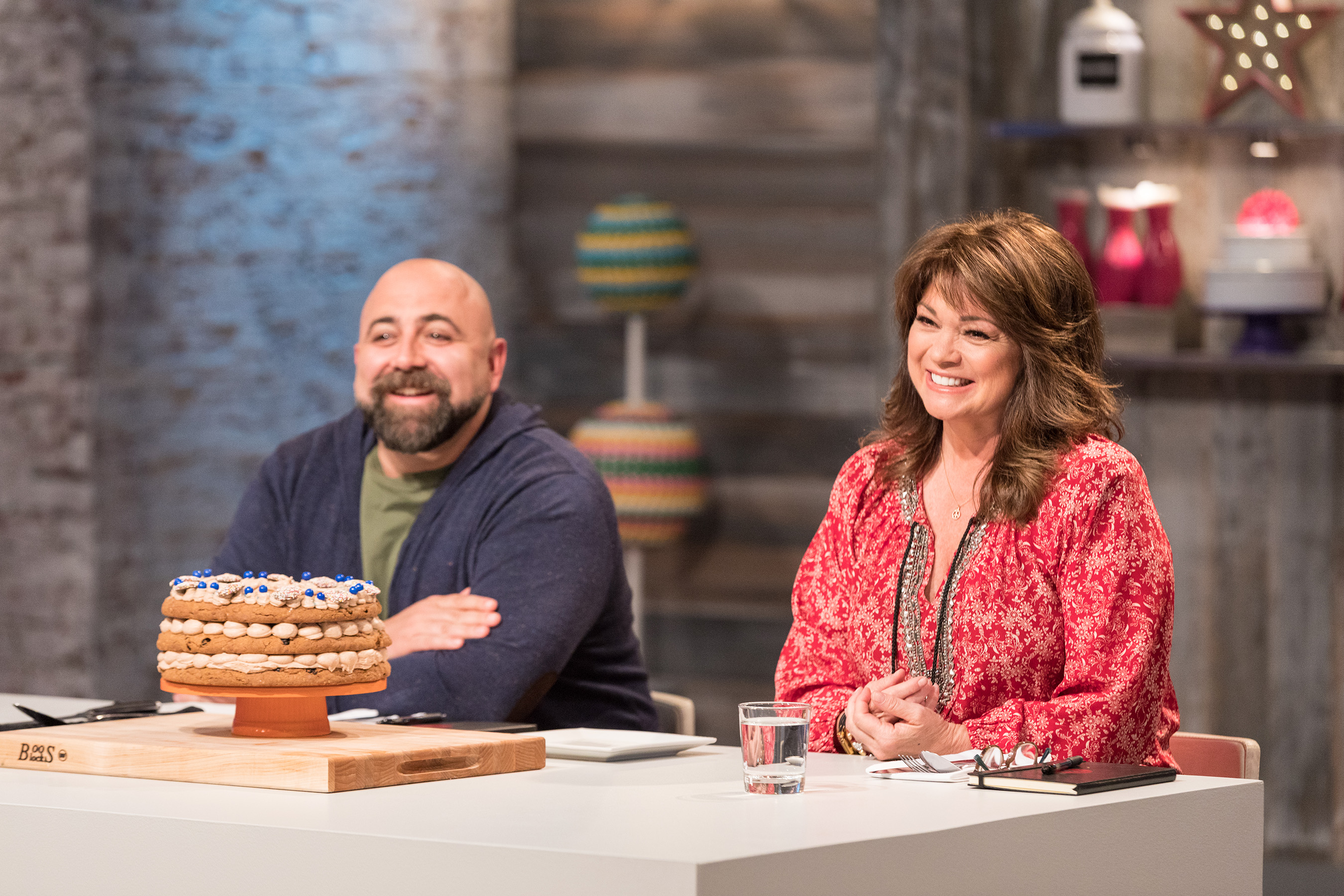 Duff Goldman and Valerie Bertinelli behind the judges table on Food Network's Kids Baking Championship