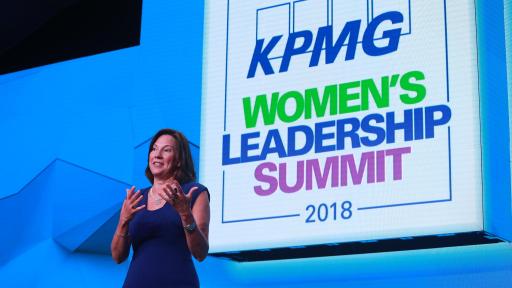 Lynne Doughtie, KPMG US Chairman and CEO standing on a stage in front of a big blue screen.