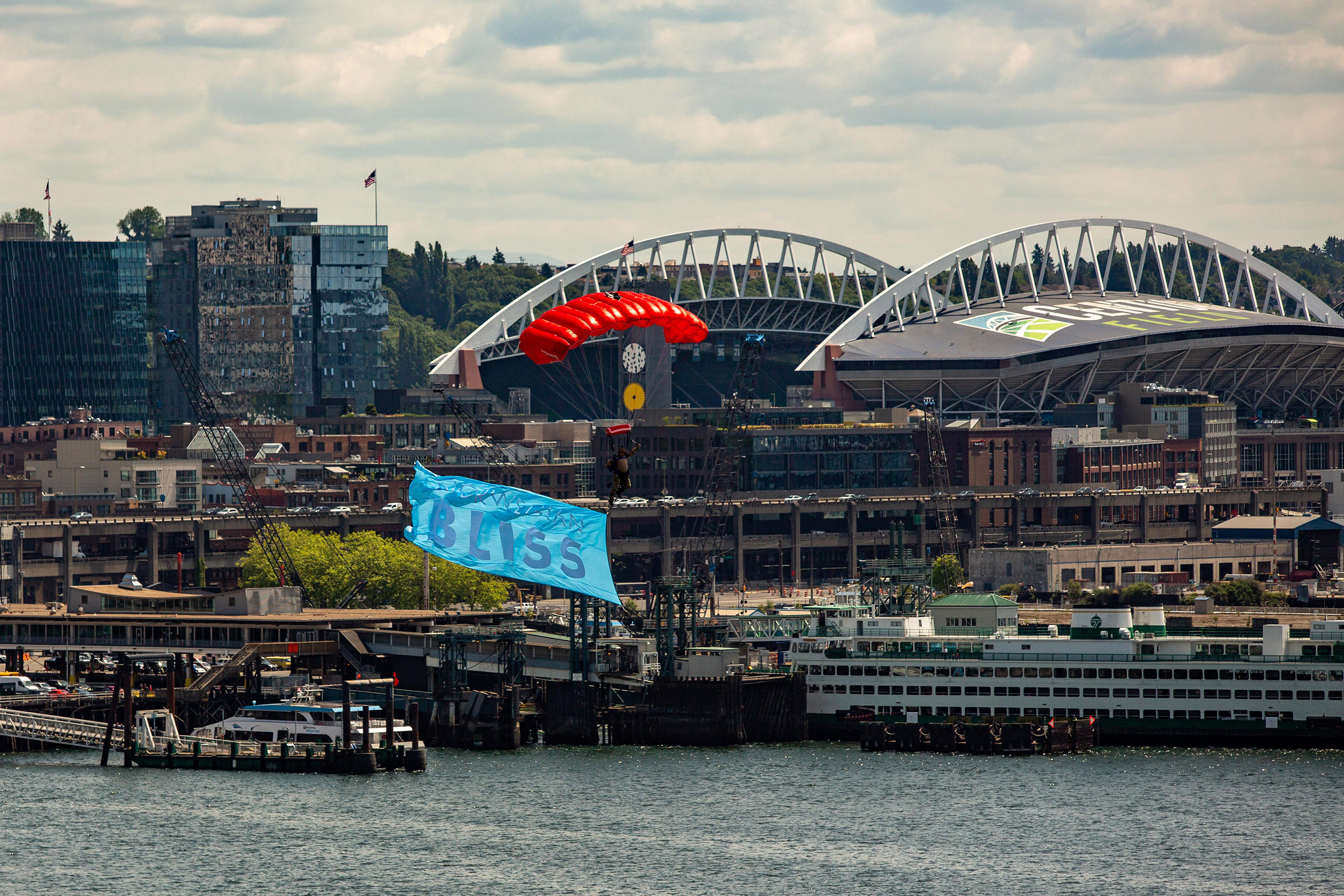 In celebration of Norwegian Bliss’ christening, skydivers descend over the ship in Seattle, Washington