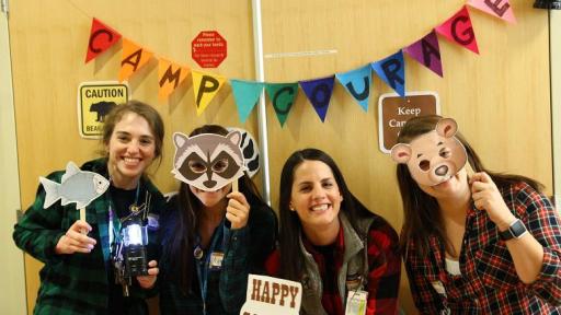 Four girls holding animal masks and signs