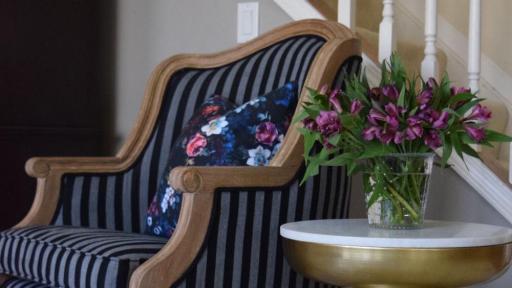 Image of chair and side table with flowers in living area