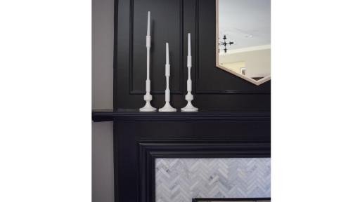 Black painted fireplace with candles on mantel