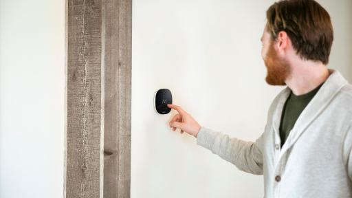 Man adjusting temperature on the ecobee thermostat