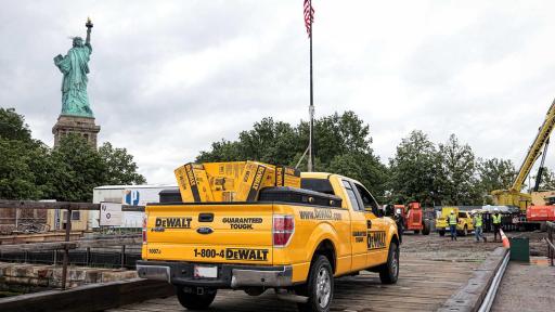Yellow DEWALT truck loaded with DEWALT boxes, headed to the Statue of Liberty Museum job site.