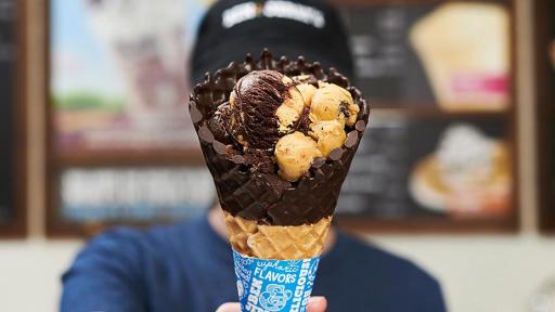 Scoops of Chocolate Dipped Waffle Cone ice cream in a chocolate dipped waffle cone.