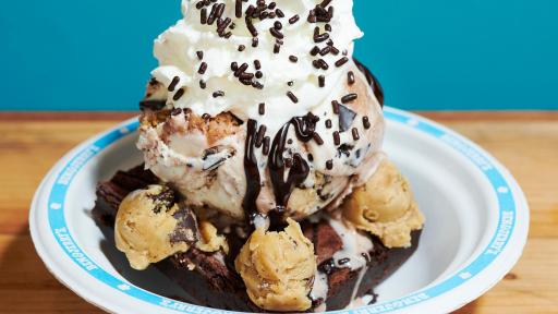 New Chip off the Dough Block ice cream in a bowl with whip cream, sprinkles, and chocolate syrup toppings.