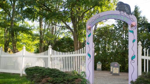 Ben & Jerry's Flavor Graveyard Entrance with white picket fence and headstones in inside.