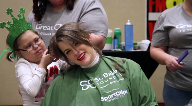Childhood cancer survivor, Sarah Rostock, shaves her head for the third time in honor of her friend and fellow survivor, Abby Furco.