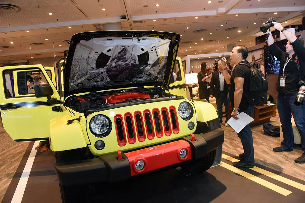 Attendees of the 2018 New York International Auto Show admire a black and white photo of South Dakota's Badland's National Park installed under the hood of Super 8's ROADM8 concept car, Thursday, March 29, 2018. Highlighting the role of black and white photography as a signature element inside the hotel brand's redesigned guest rooms, the piece gives an intentional nod to the brand's South Dakota roots. ROADM8 is a road-trip-concept car created by Super 8 to uniquely showcase the brand's redesigned...
