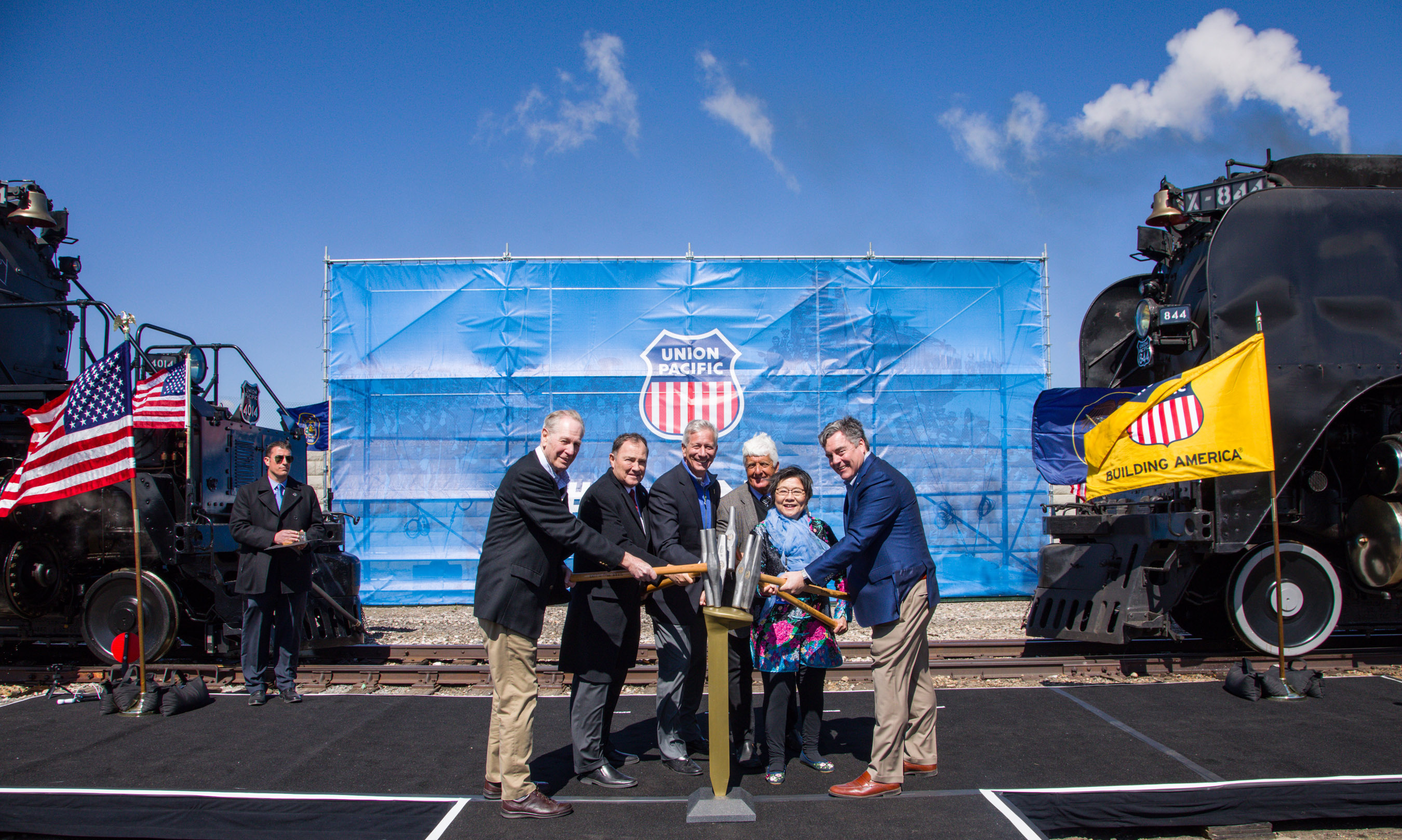 Tapping a ceremonial Golden Spike from left are Sandy Dodge, descendent of Gen. Grenville Dodge; Utah Gov. Gary Herbert, Union Pacific Chairman, President and CEO Lance Fritz, Utah Congressman Rob Bishop, Margarat Yee, a descendent of a Central Pacific employee, and Scott Moore, Union Pacific senior vice president-Corporate Relations and chief administrative officer.