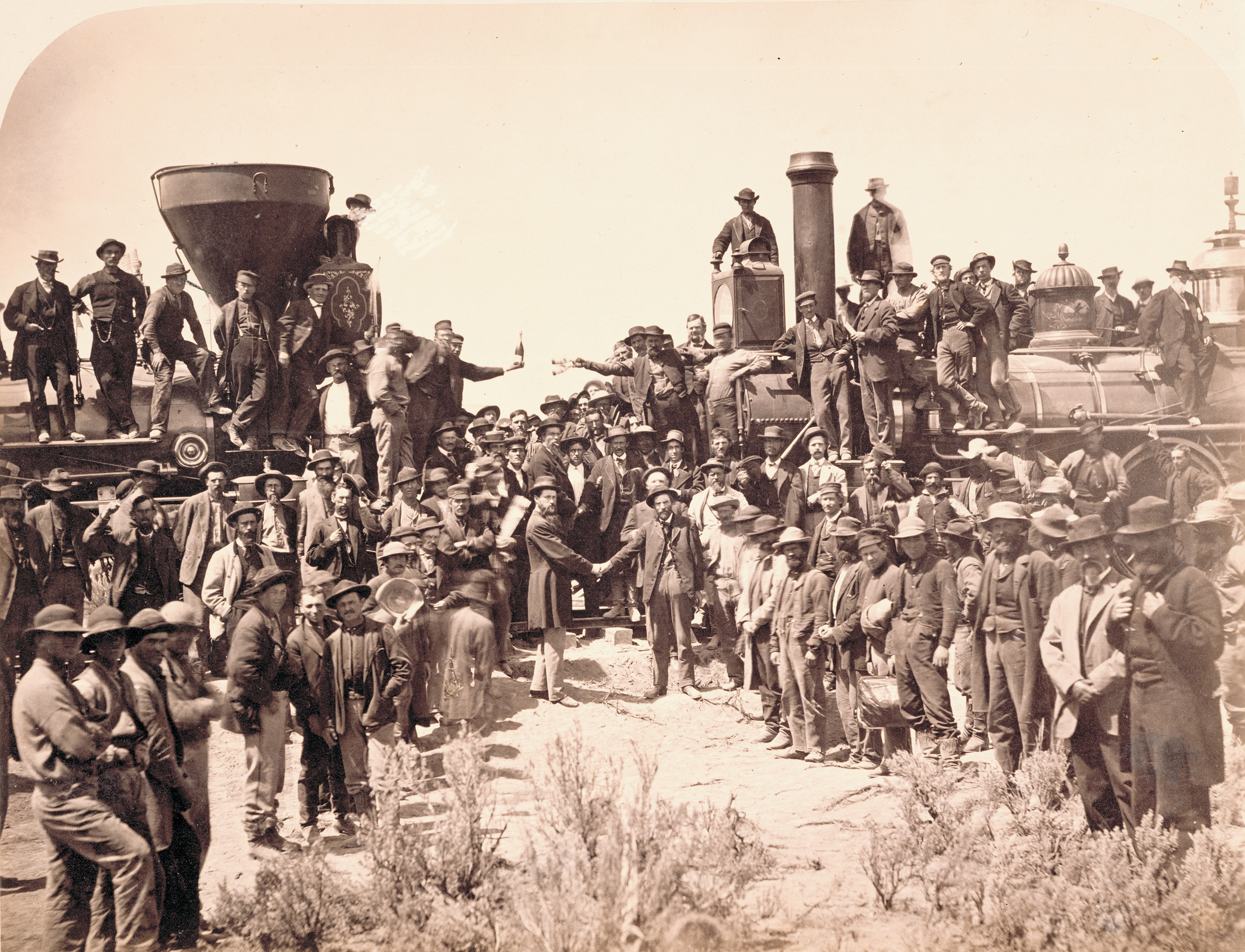 East and West shaking hands at laying of the last rail, Promontory Summit, Utah. Photograph was taken by Andrew Russell May 10, 1869. General Grenville Dodge, chief engineer for Union Pacific, is pictured shaking hands on the right with Central Pacific engineer Samuel Montague.