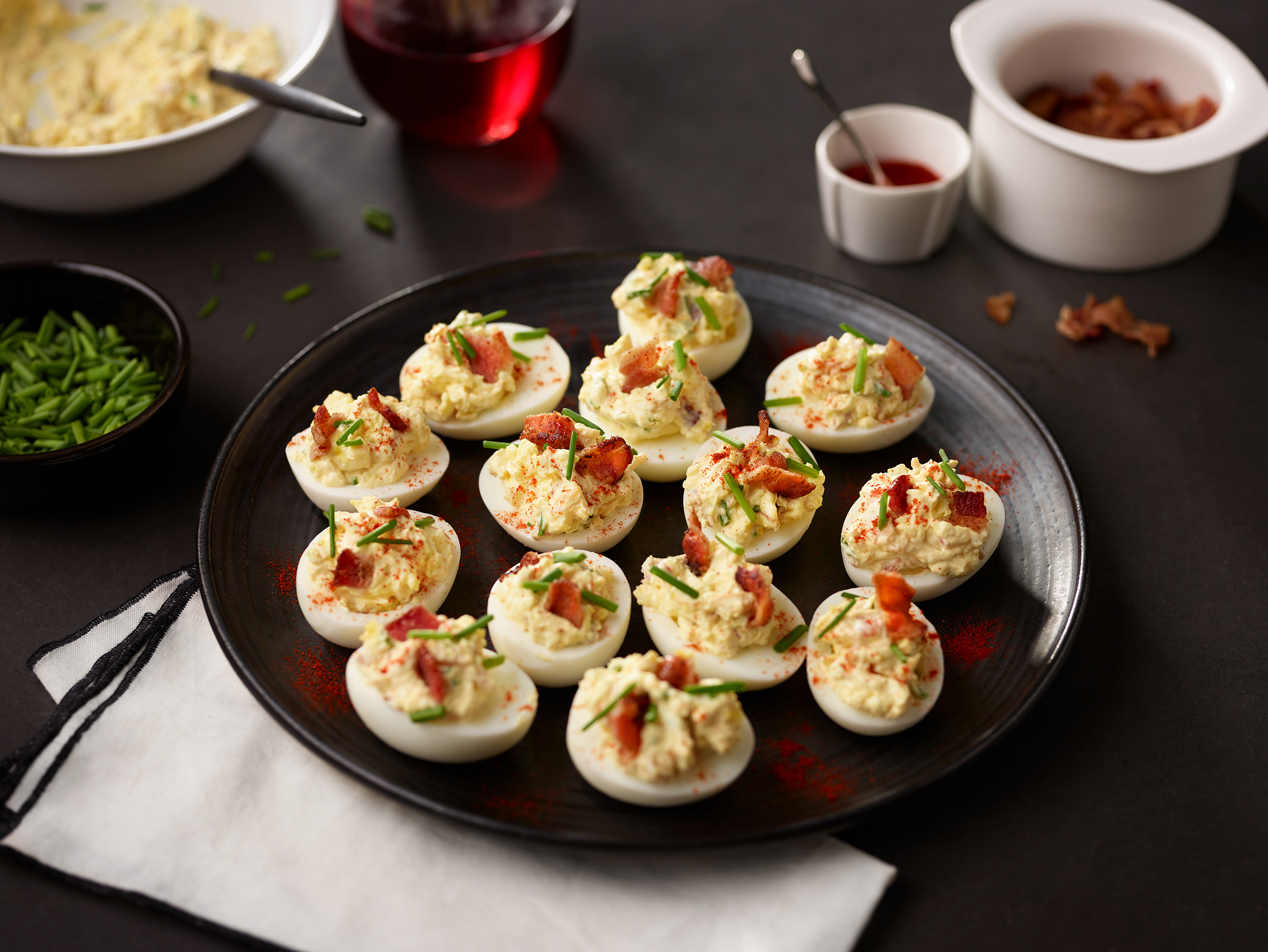 These heavenly deviled eggs include crumbled bacon, shredded cheddar cheese and fresh chives.