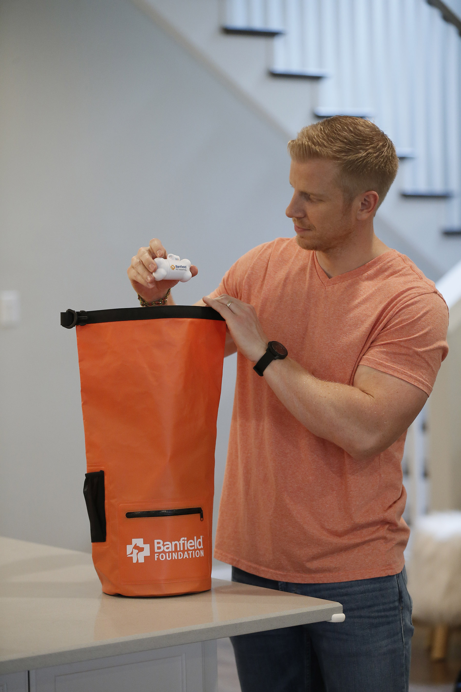 TV personality Sean Lowe packs his pet disaster preparedness kit while filming a PSA with the Banfield Foundation at his home in Dallas, Texas. The waterproof kit contains critical supplies such as a blanket, treats, stress-relief products, water and food calculation charts, tips and checklists to help keep pets cared for in the event of a natural disaster. The PSA debuted nationally on June 6, 2018. (Photo credit: Brandon Wade/AP Images for the Banfield Foundation)