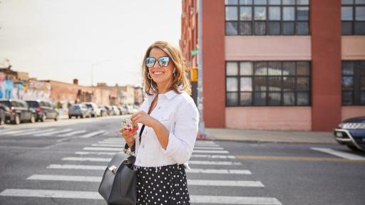 Victoria Arlen with headphones and sunglasses on walking through the city
