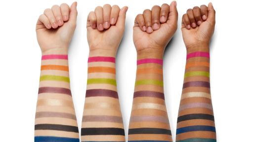 4 arms of various shades with the eye makeup colors in stripes on the arms.